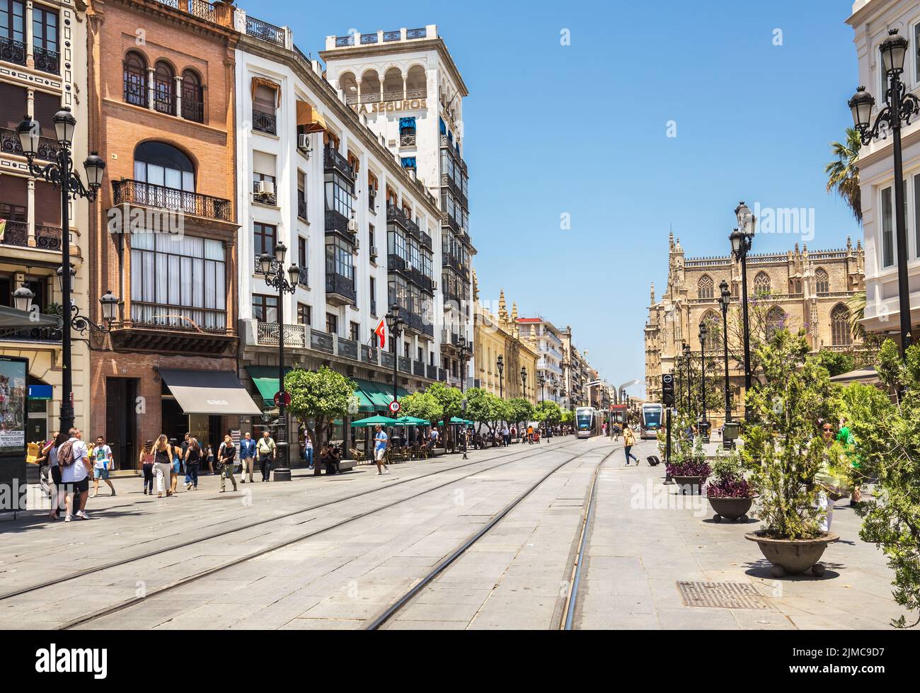 Street with rails for tram in the city center of Seville Stock Photo