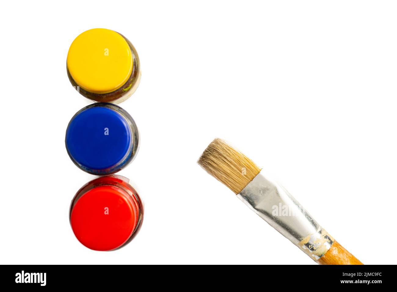 Top view of opened bottles of primary color on white background. Stock Photo
