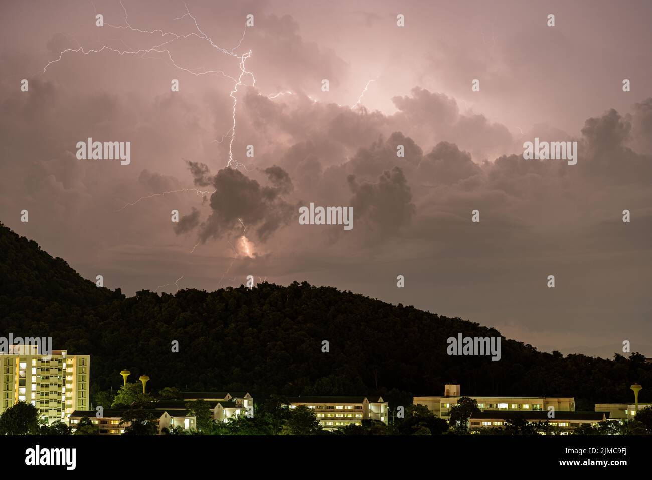 Storm lightning strikes in mountains during a thunderstorm at night. Beautiful dramatic view Stock Photo