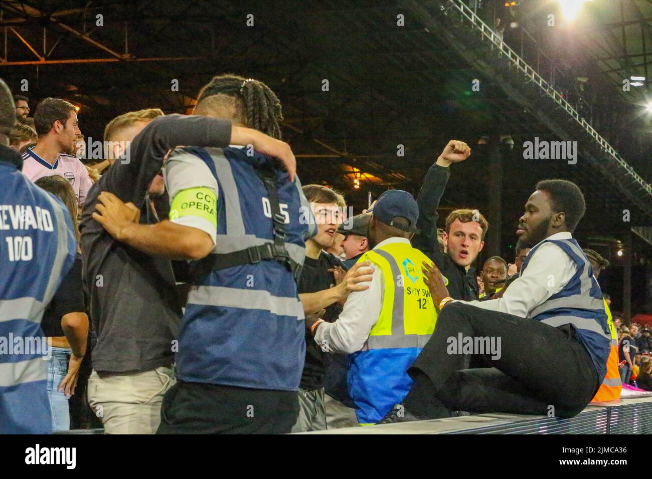 London, UK. 5th August 2022; Selhurst Park, Crystal Palace, London, England; Premier League football, Crystal Palace versus Arsenal: Stewards struggle to hold back Arsenal fans celebrating 0-2 and trying to get onto the pitch Credit: Action Plus Sports Images/Alamy Live News Stock Photo