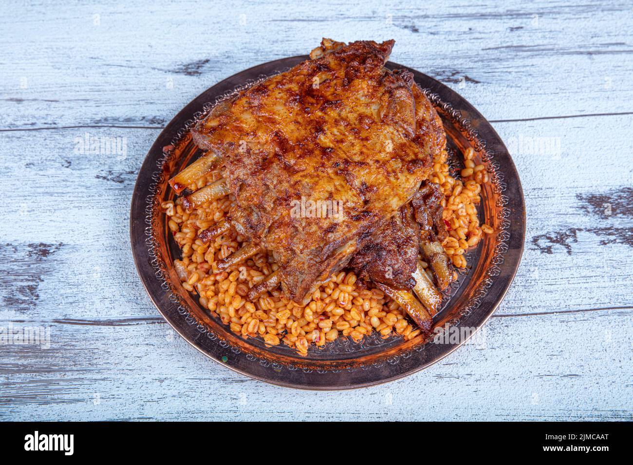Lamb ribs on bulgur pilaf. Stuffed Ribs isolated on black background