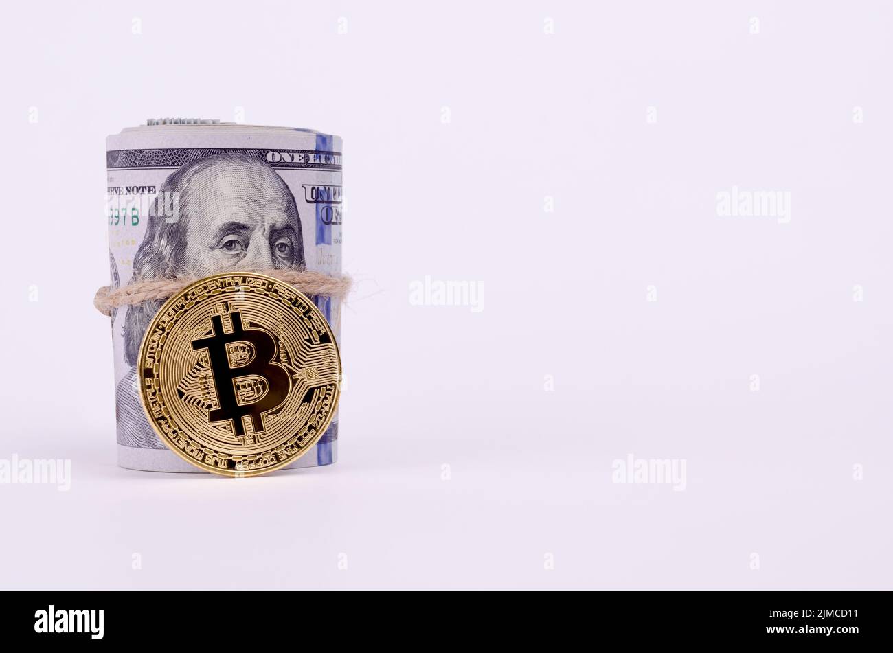 Shiny Gold Dollar Sign Necklace and Physical Bitcoin on a United States  Dollar Bills. Financial business background Stock Photo - Alamy