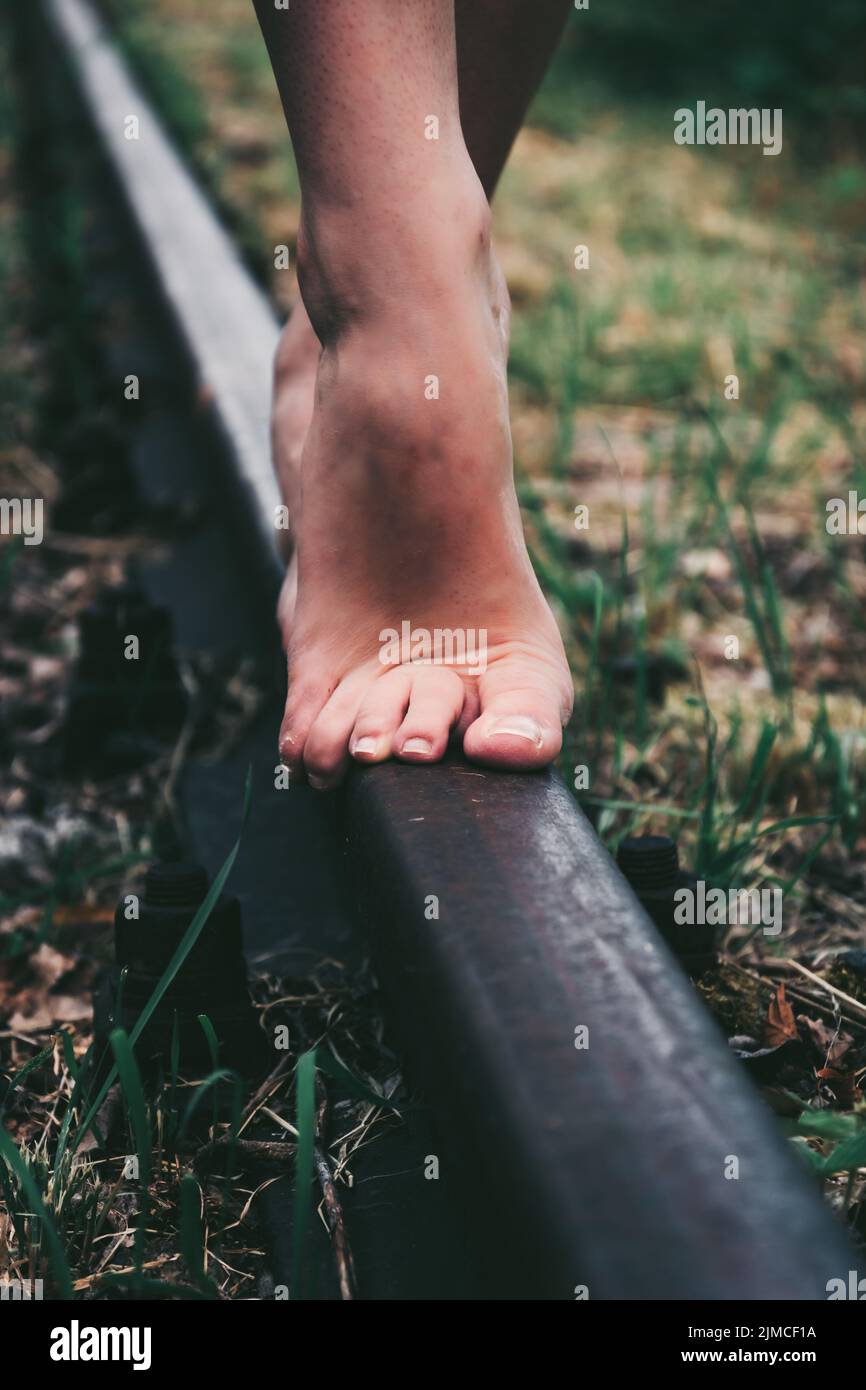 Balance barefoot on a railway line Stock Photo