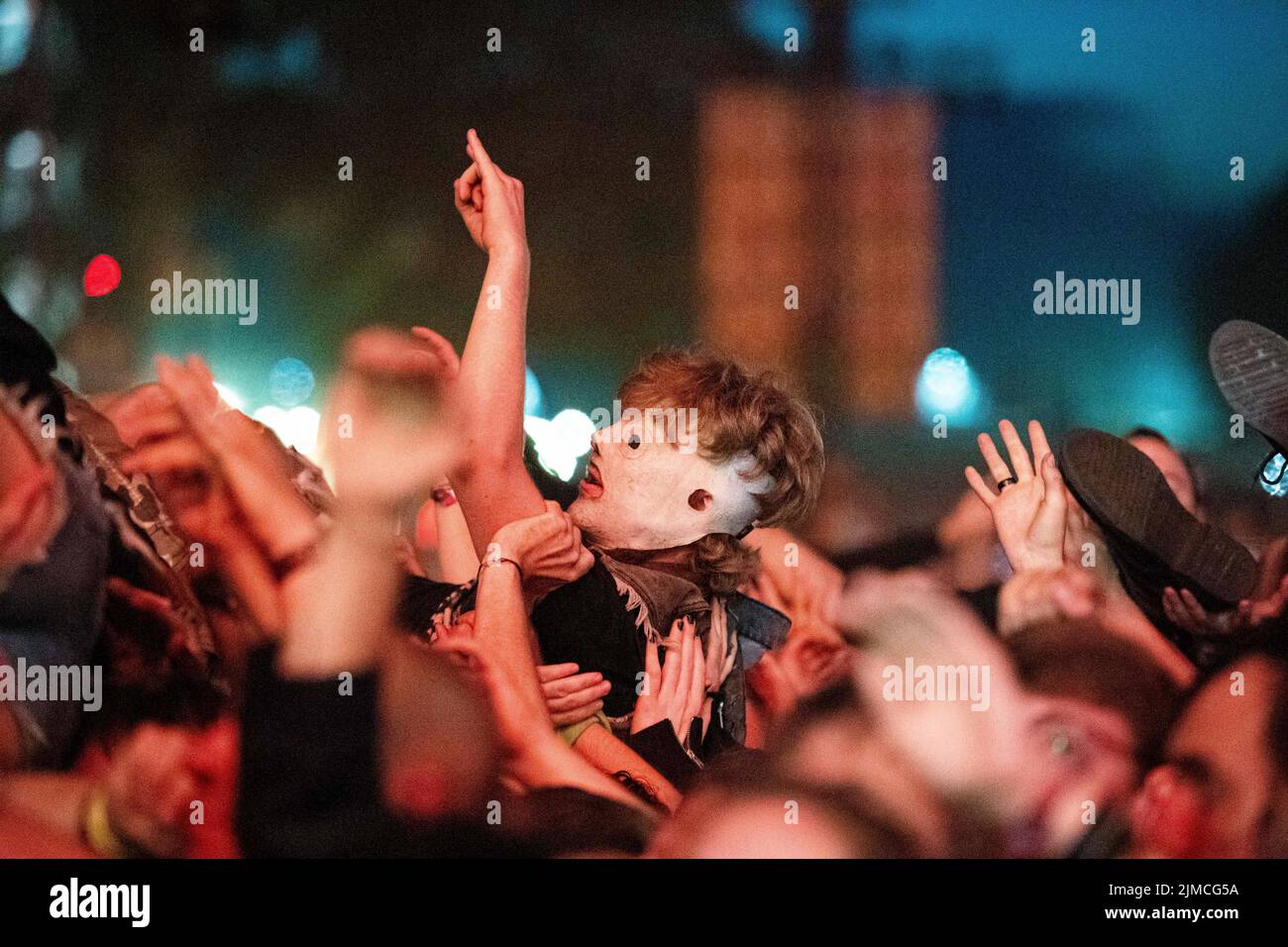 Wacken, Germany. 05th Aug, 2022. A festival-goer is carried over the crowd while crowdsurfing during the concert of the band Slipknot at the Wacken Open Air Festival. The WOA is considered the largest heavy metal festival in the world. Credit: Daniel Reinhardt/dpa/Alamy Live News Stock Photo