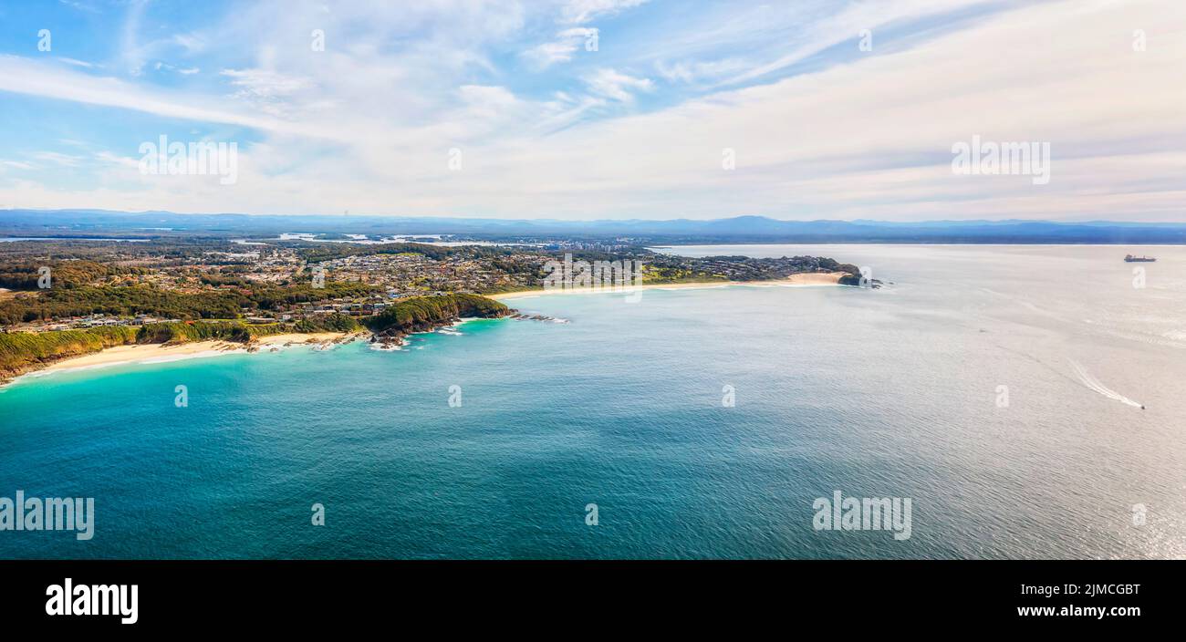 Burgess and One mile beaches on Pacific coast of Forster town of Australia - aerial townscape from open sea to Wallis lake. Stock Photo