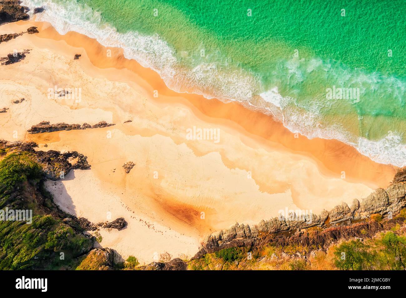 Tiny secluded neat burgess beach in Forster town on PAcific ocean coast of Australia - top down aerial view. Stock Photo
