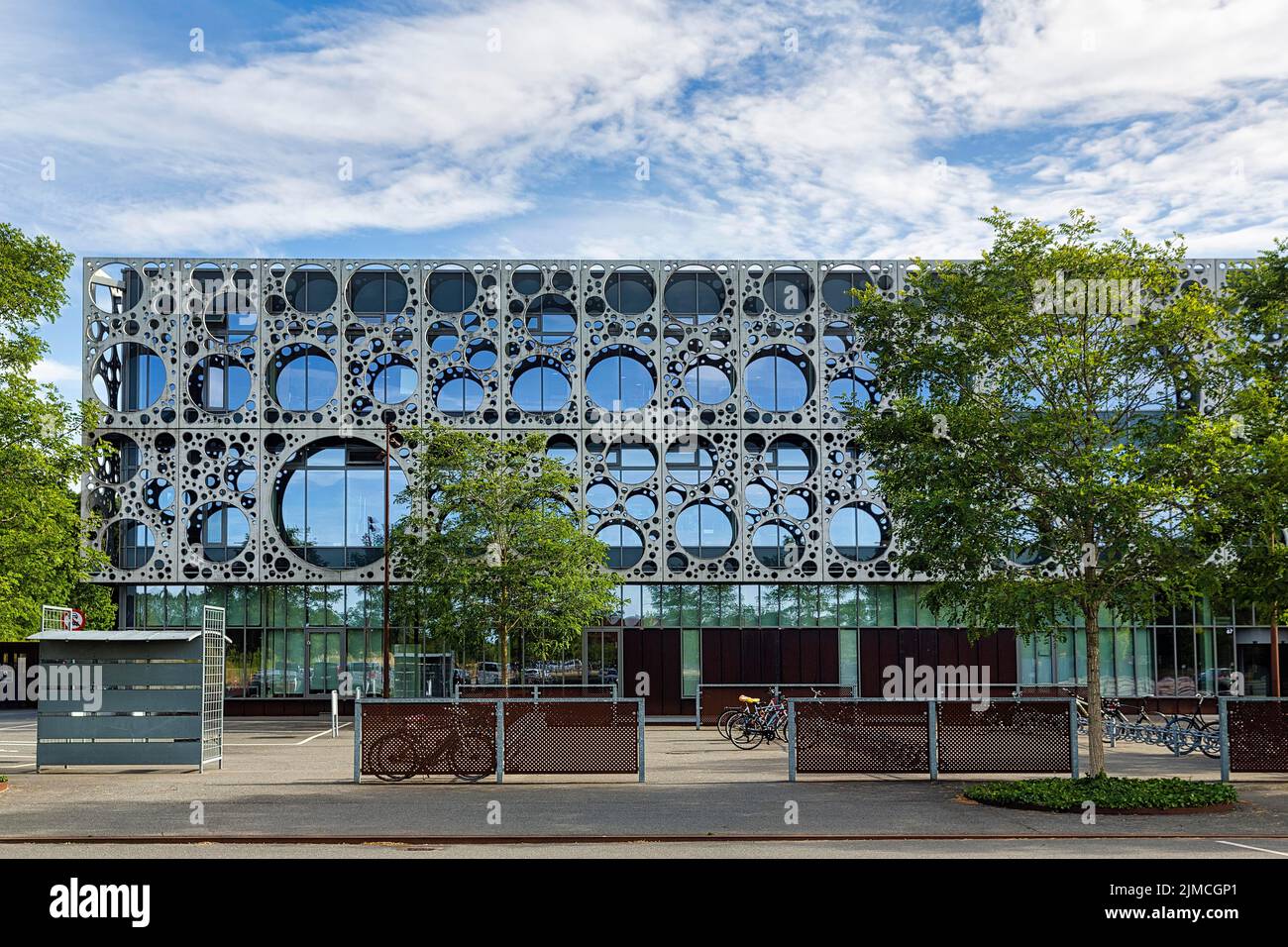 Faculty of Technology, University of Southern Denmark, Syddansk Universitet, SDU, facade of glass and metal, circular hole pattern in metal panels Stock Photo