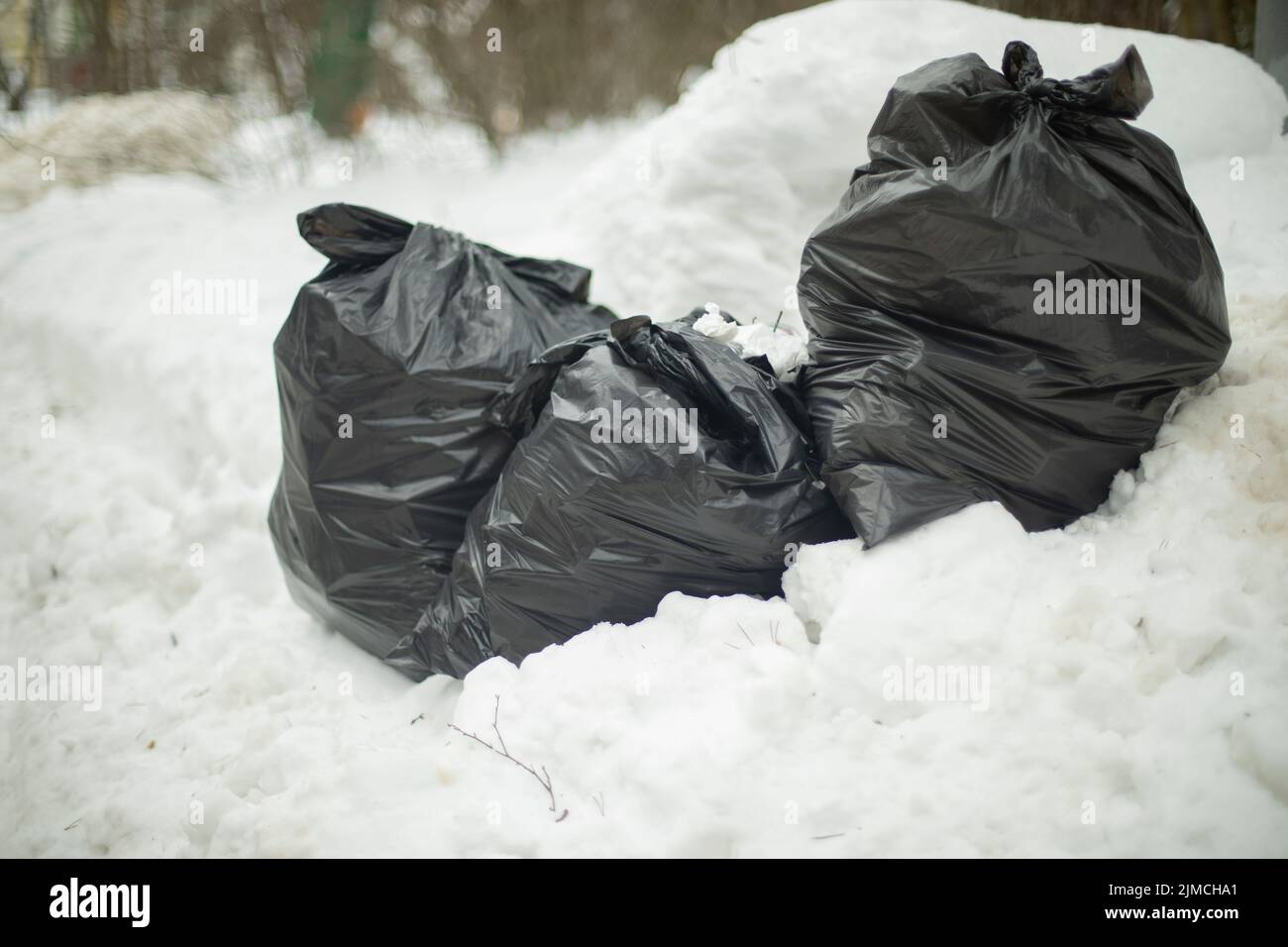 Three big blacks trash bags in front of wall Stock Photo - Alamy