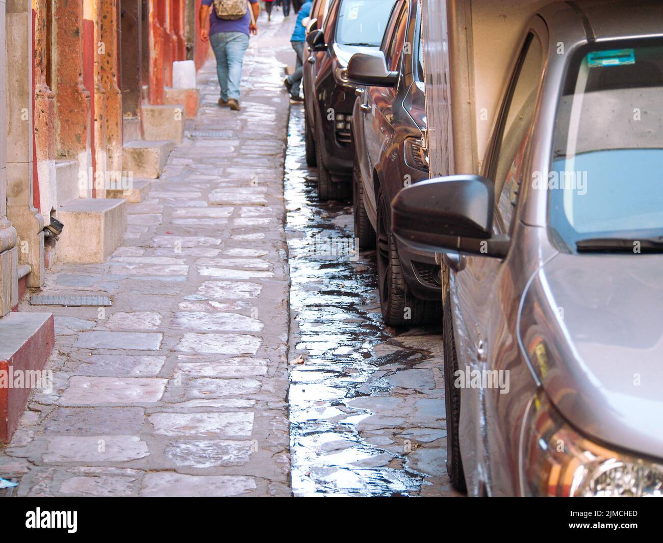 Narrow historic cobblestone sidewalk in Mexico Stock Photo