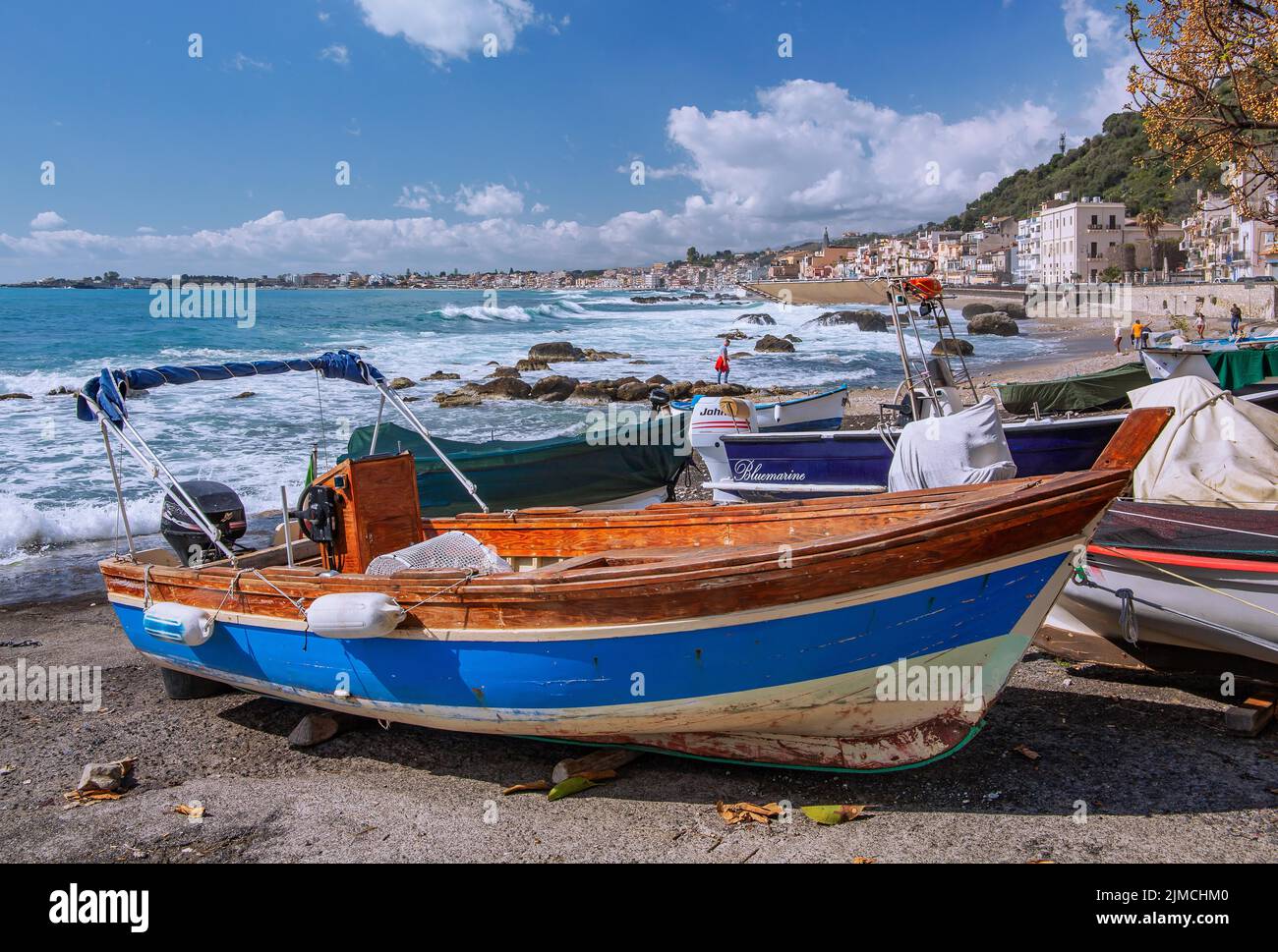 Sea surf in front of the promenade with fishing boats, Giardini-Naxos, east coast, Sicily, Italy Stock Photo