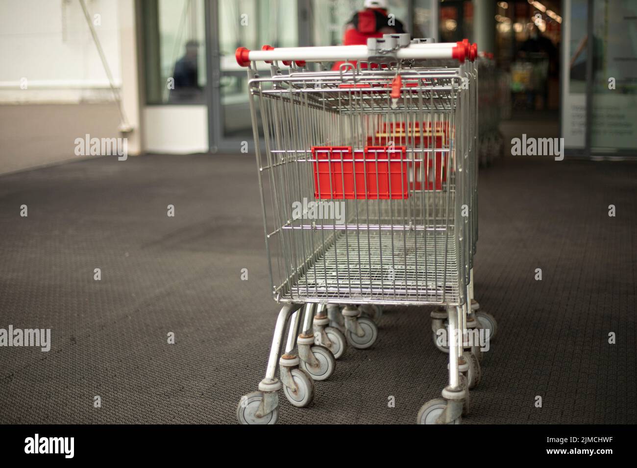 Food baskets are lined up in long row. Shopping cart. Background
