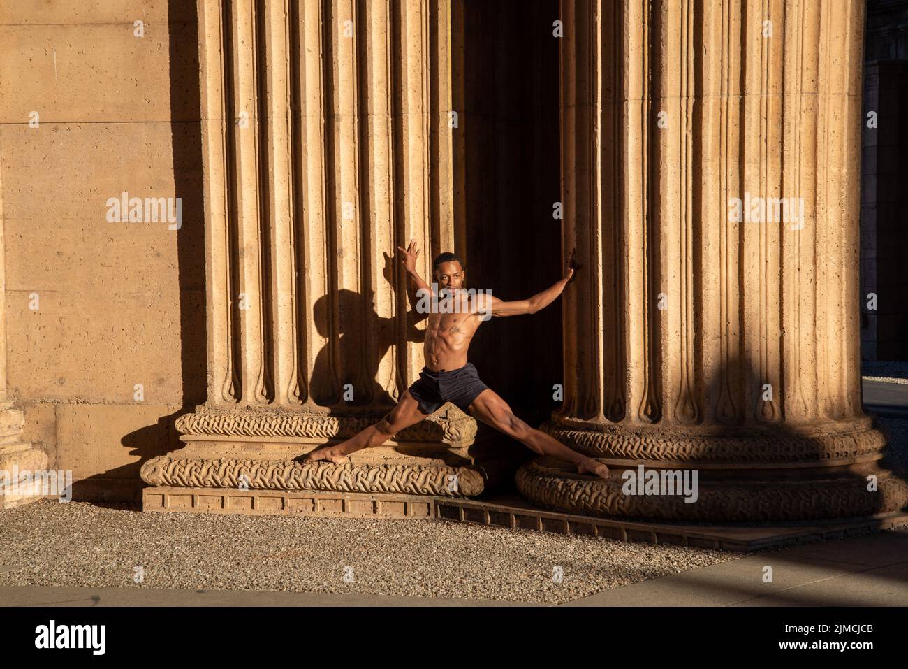 Magnificent male ballet dancer standing between two collumns Stock Photo