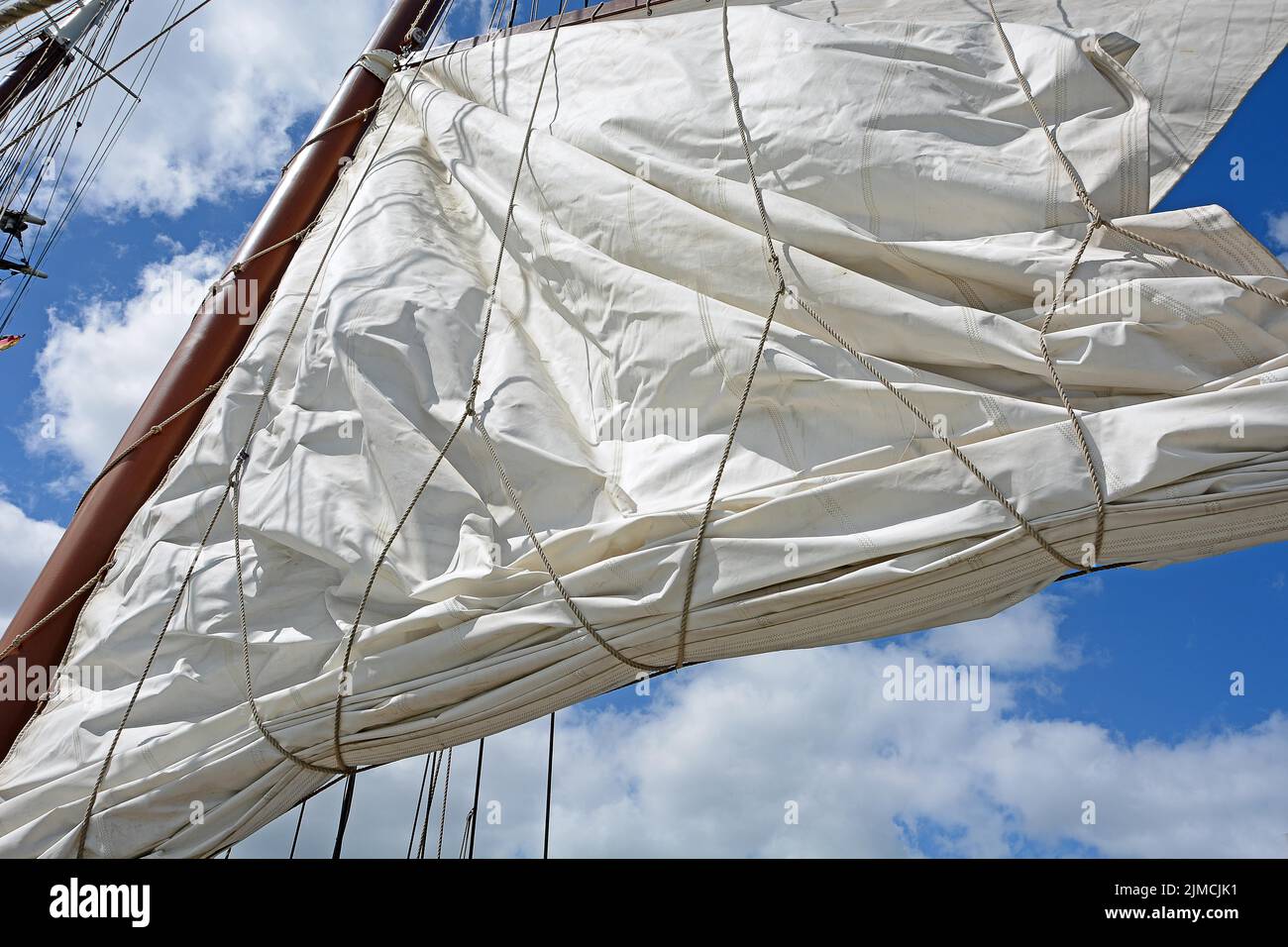 White sail hoisting, Baltic Sea Stock Photo