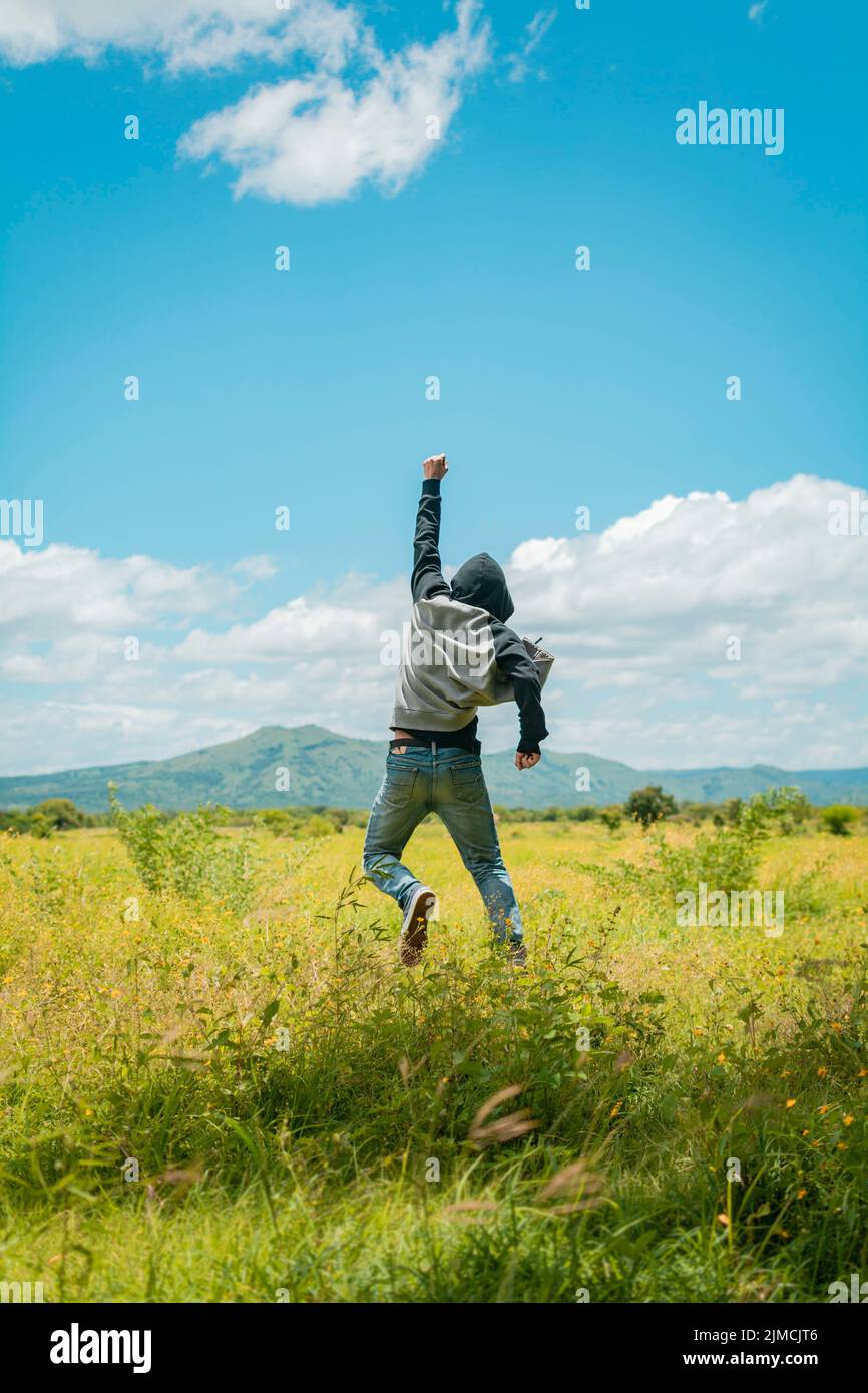 Concept of a free person jumping and raising his arm, Free person