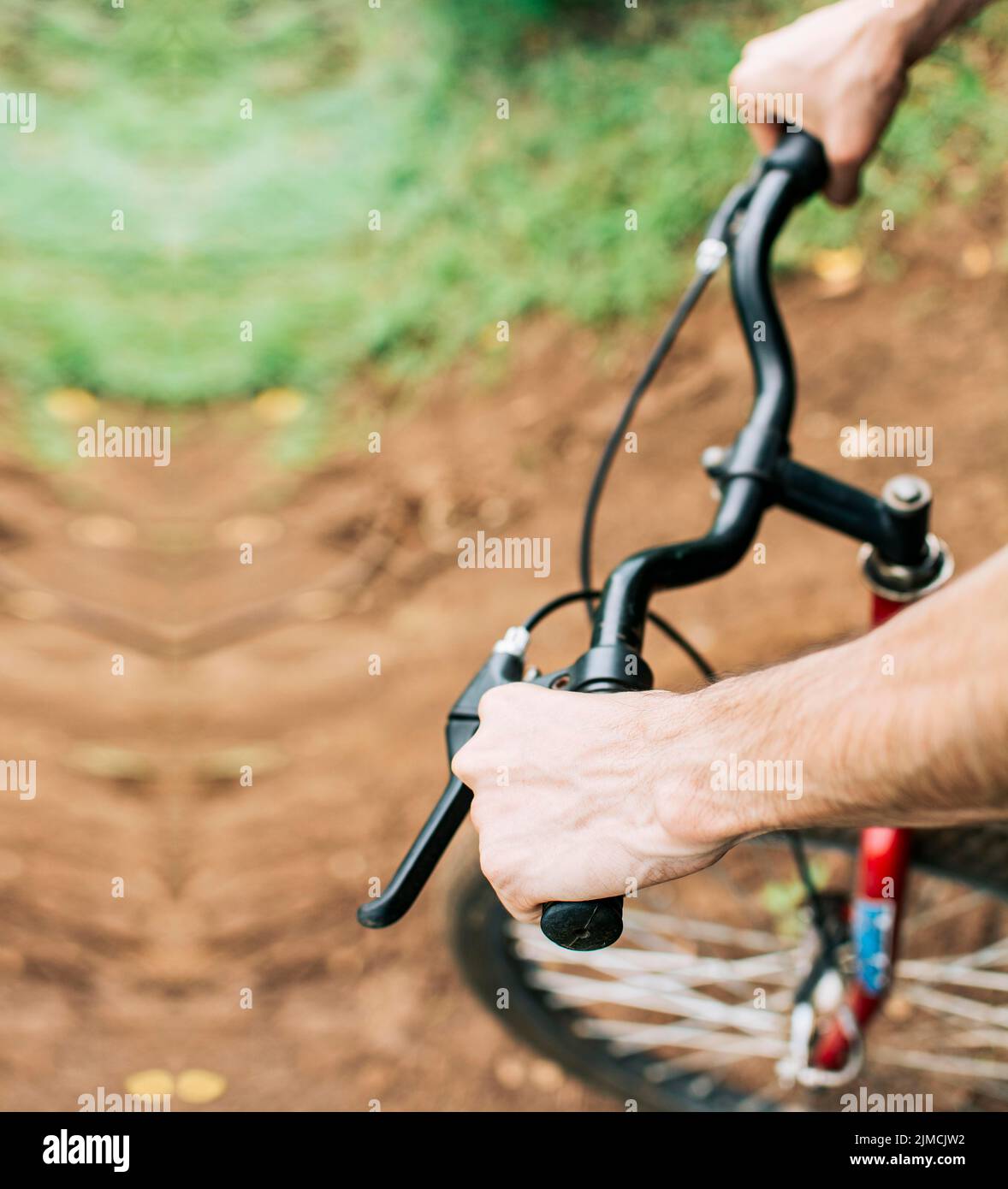 High angle of hands on bicycle handlebars, Side view of hands on
