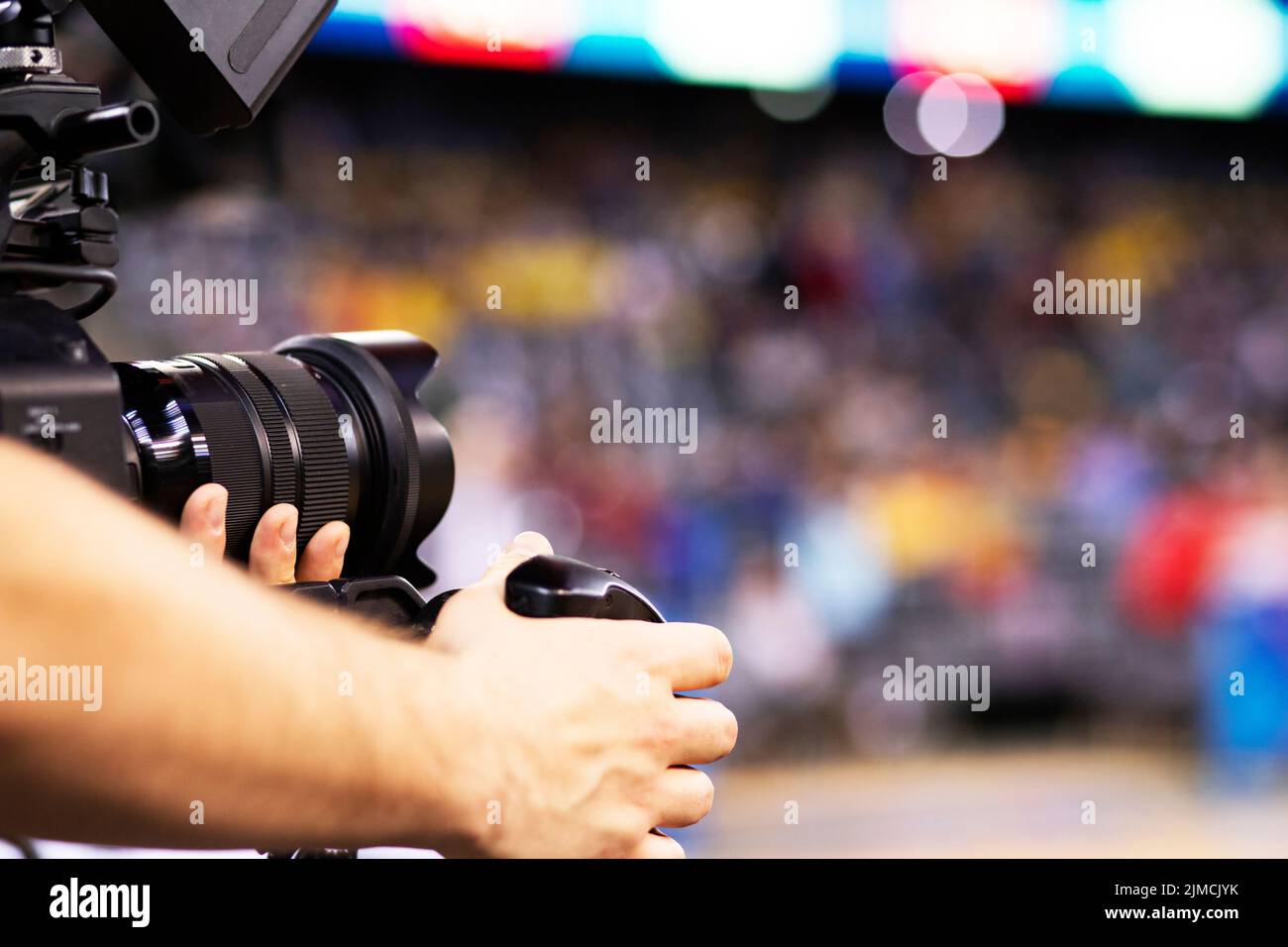 Professional cameraman recording sporting event Stock Photo Alamy