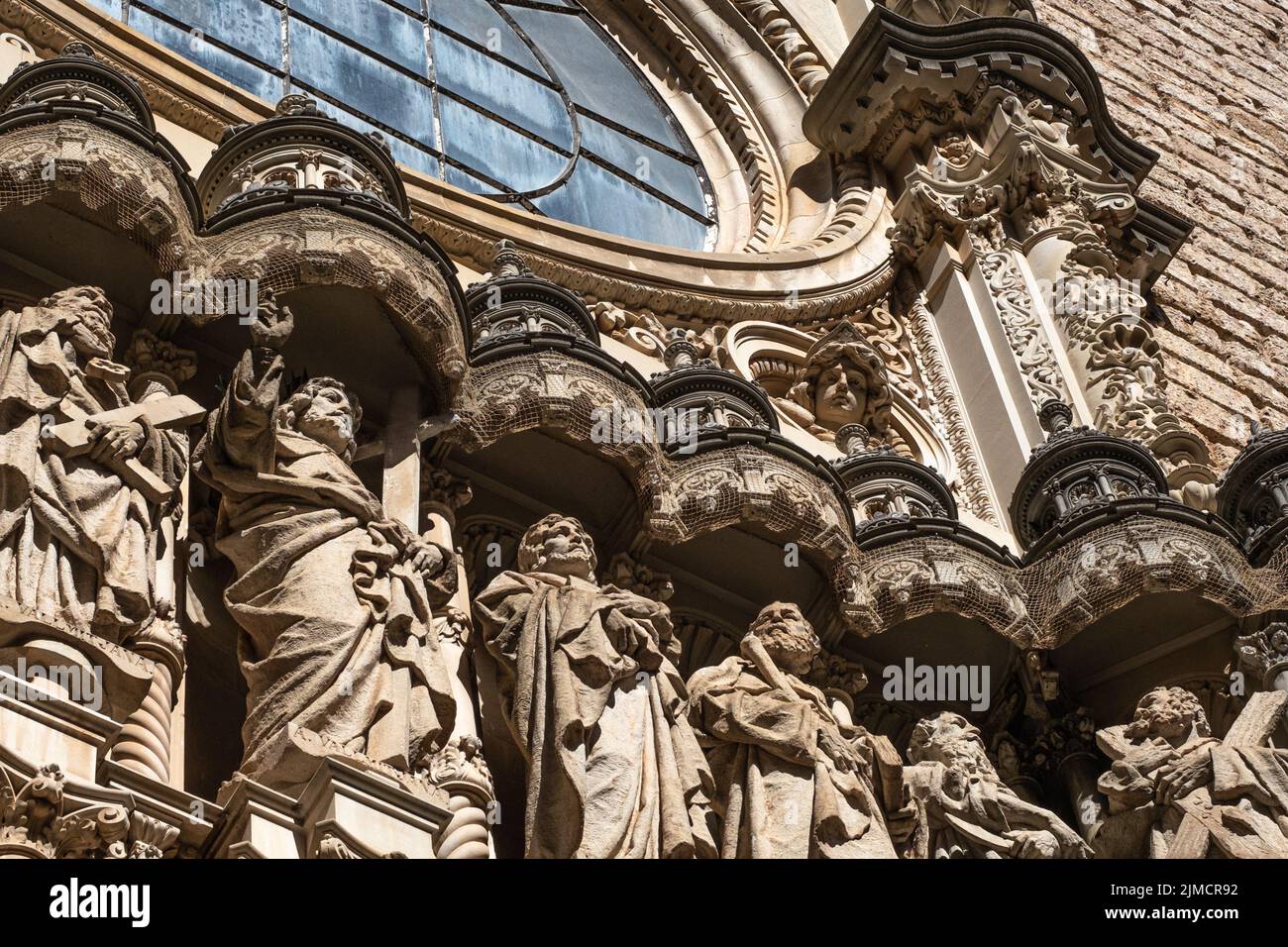 Detail of the exterior facade of the basilica of the Monastery of Montserrat in Spain. The statue of Jesus Christ and part of the twelve apostles. Stock Photo