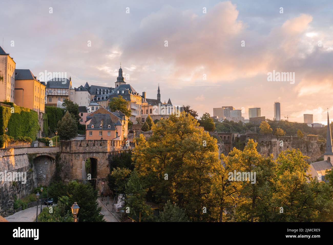Scenic cityscape with typical aged residential buildings located on famous Chemin de la Corniche street against picturesque cloudy sunset sky in Luxem Stock Photo