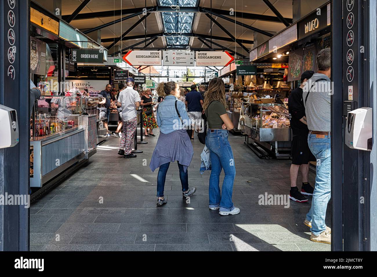 Visitors in the Torvehallerne market hall with street food and