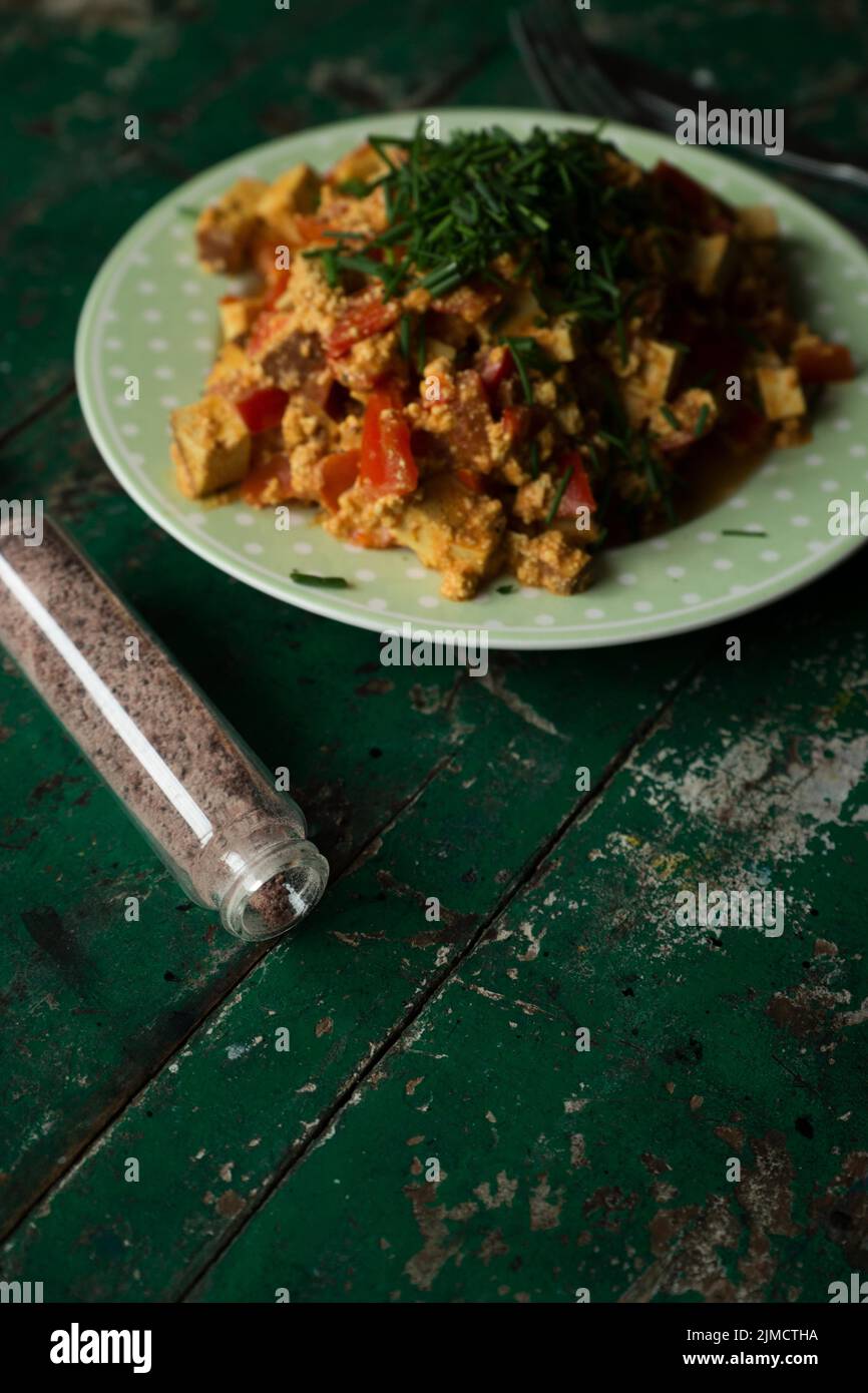 Vegan scrambled eggs with smoked tofu, chives and salt Stock Photo
