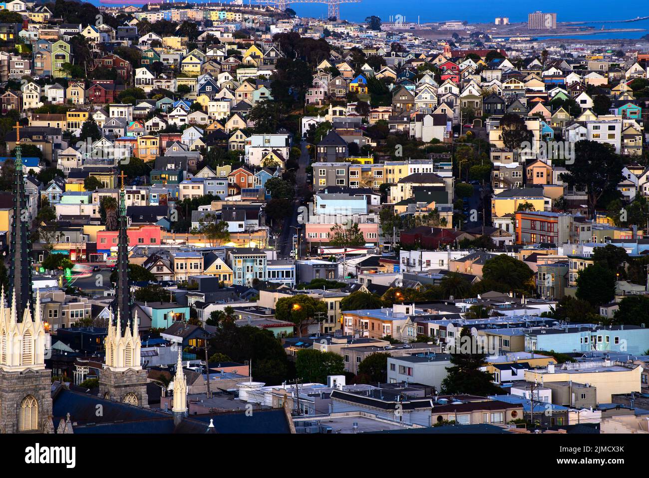 Rolling San Francisco hills with peaked roof homes and streets at golden hour Stock Photo