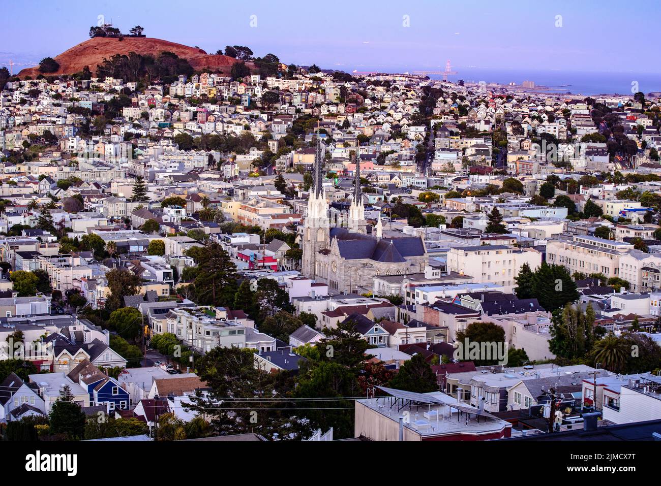 Rolling San Francisco hills with peaked roof homes and streets at golden hour Stock Photo