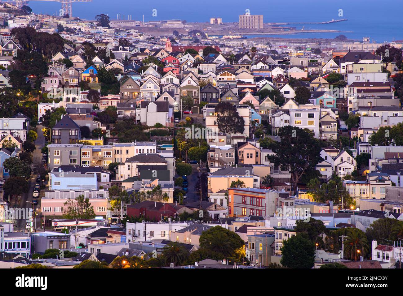 Rolling San Francisco hills with peaked roof homes and streets at golden hour Stock Photo