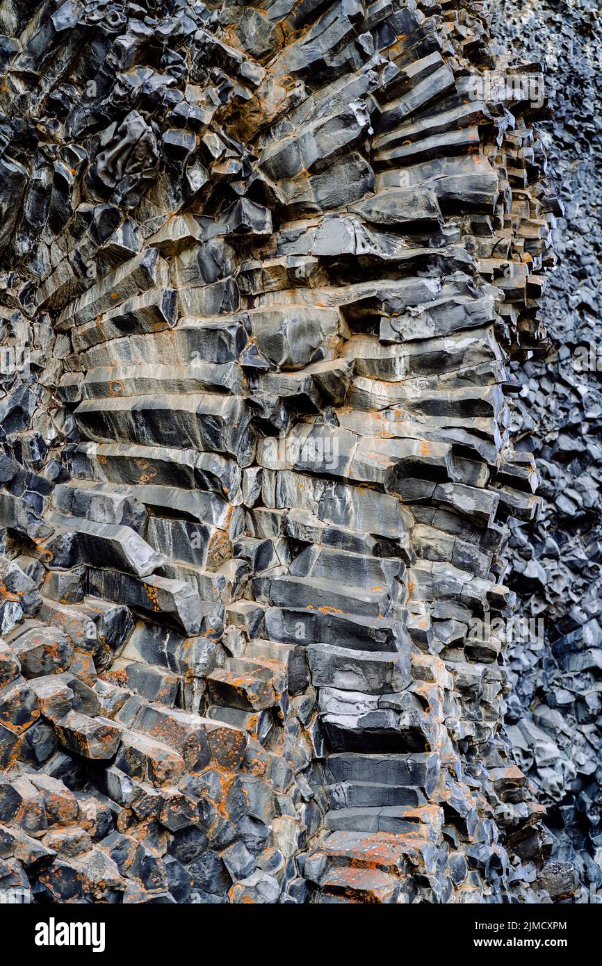 From below of textured surface of columnar basalt rock formation as