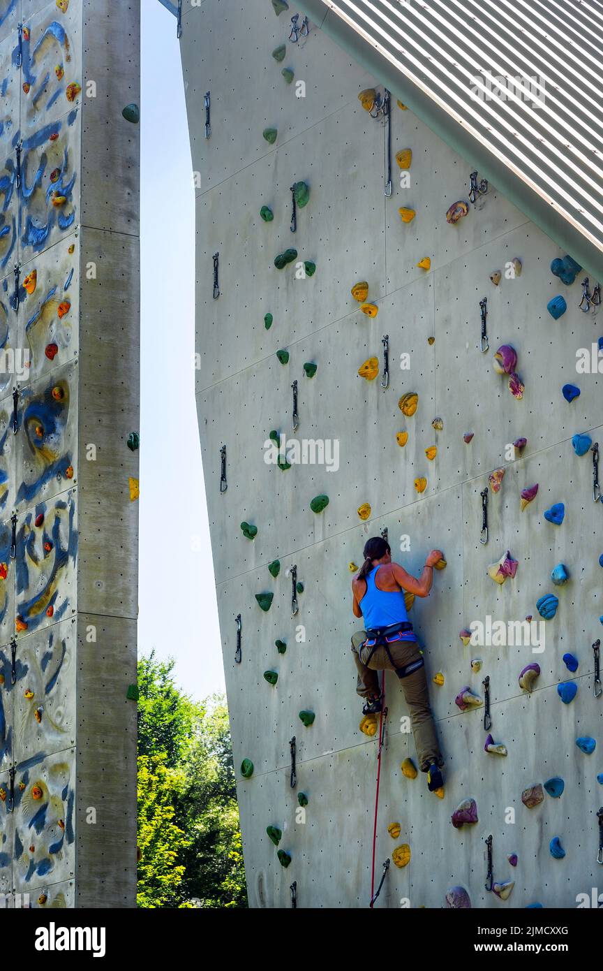 Woman hanging on climbing wall, climbing tower of the German Alpine Club, Engelhaldepark