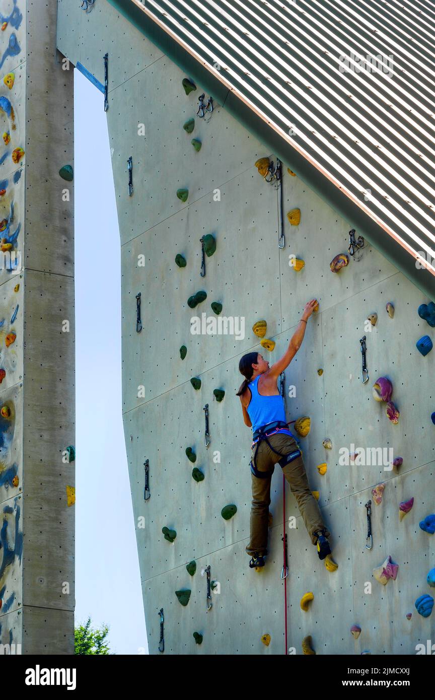Woman hanging on climbing wall, climbing tower of the German Alpine ...