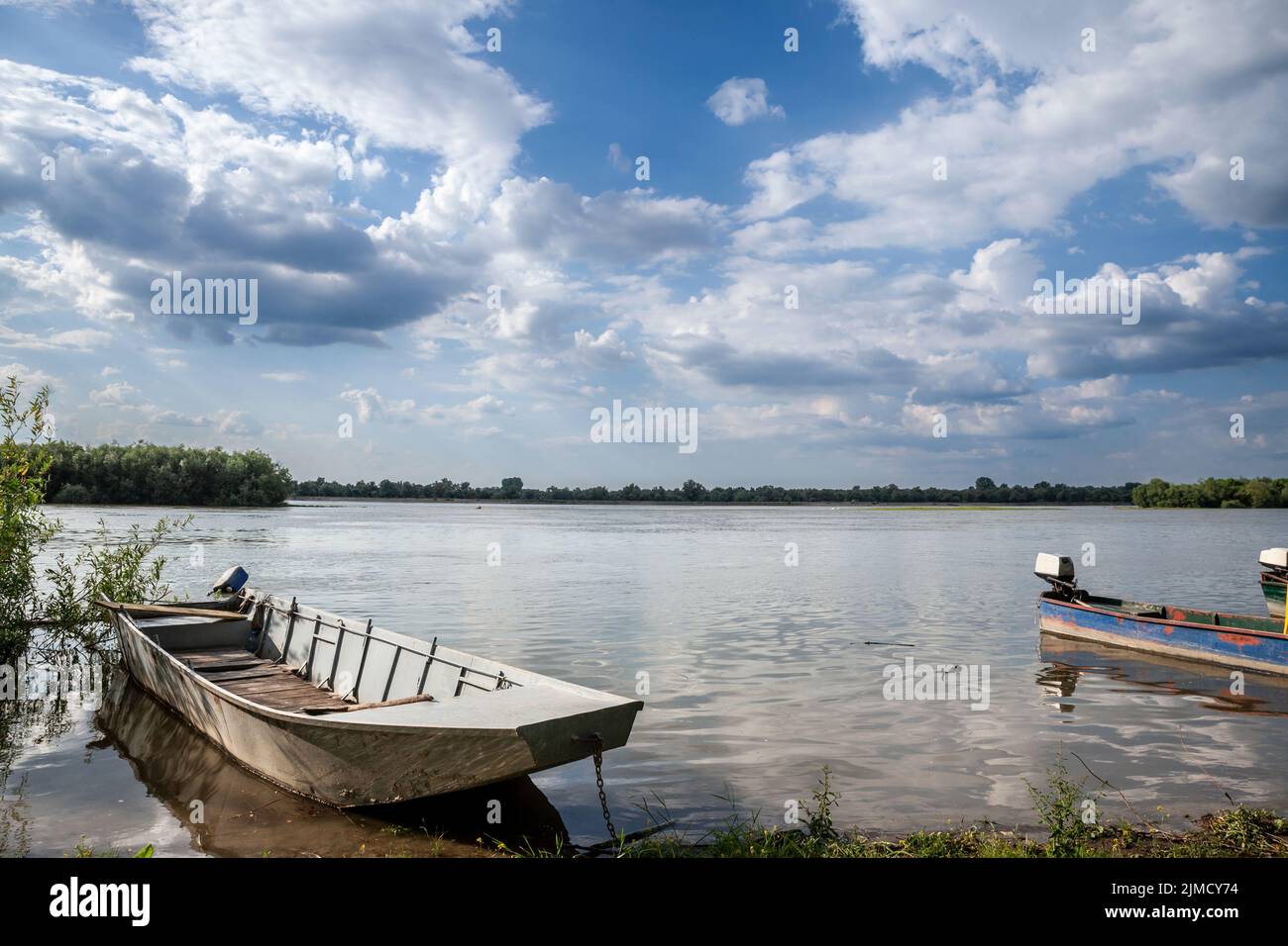 Old boats anchord on a shore on the Danube river in Serbia, during a sunny afternoon in Krcedin, Vojvodina. The Danube is the biggest river on Central Stock Photo