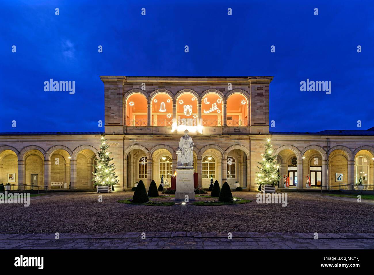 Christmas illuminated arcade building at dusk, Rossini Hall, arcade passage, classicism, in front monument to King Ludwig I of Bavaria, spa garden Stock Photo