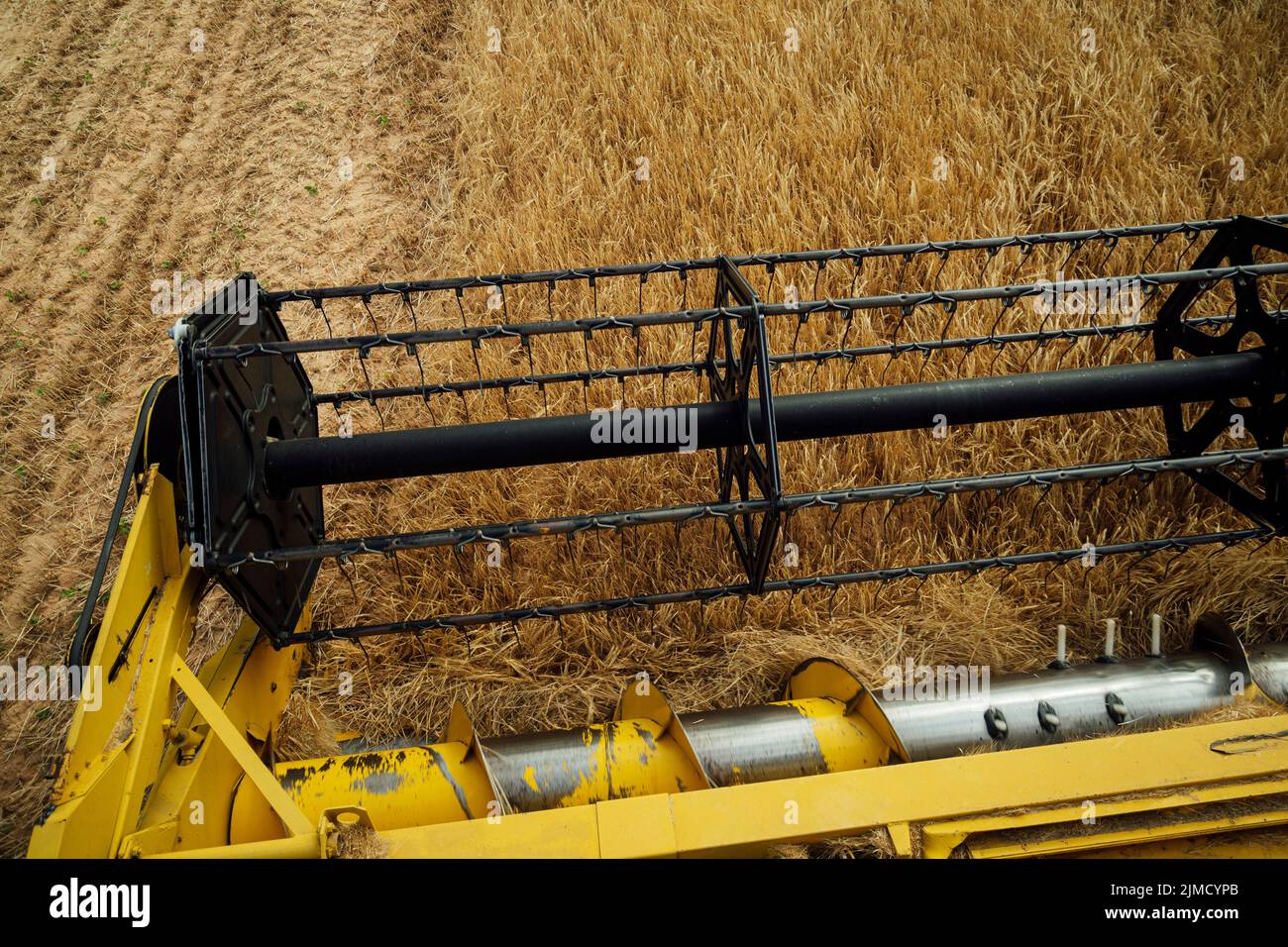 From above of industrial combine harvester with metal revolving reel