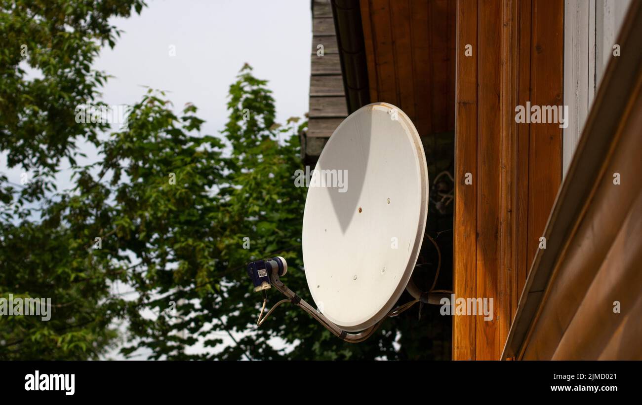 Satellite antenna in the house. White antenna to receive the TV signal