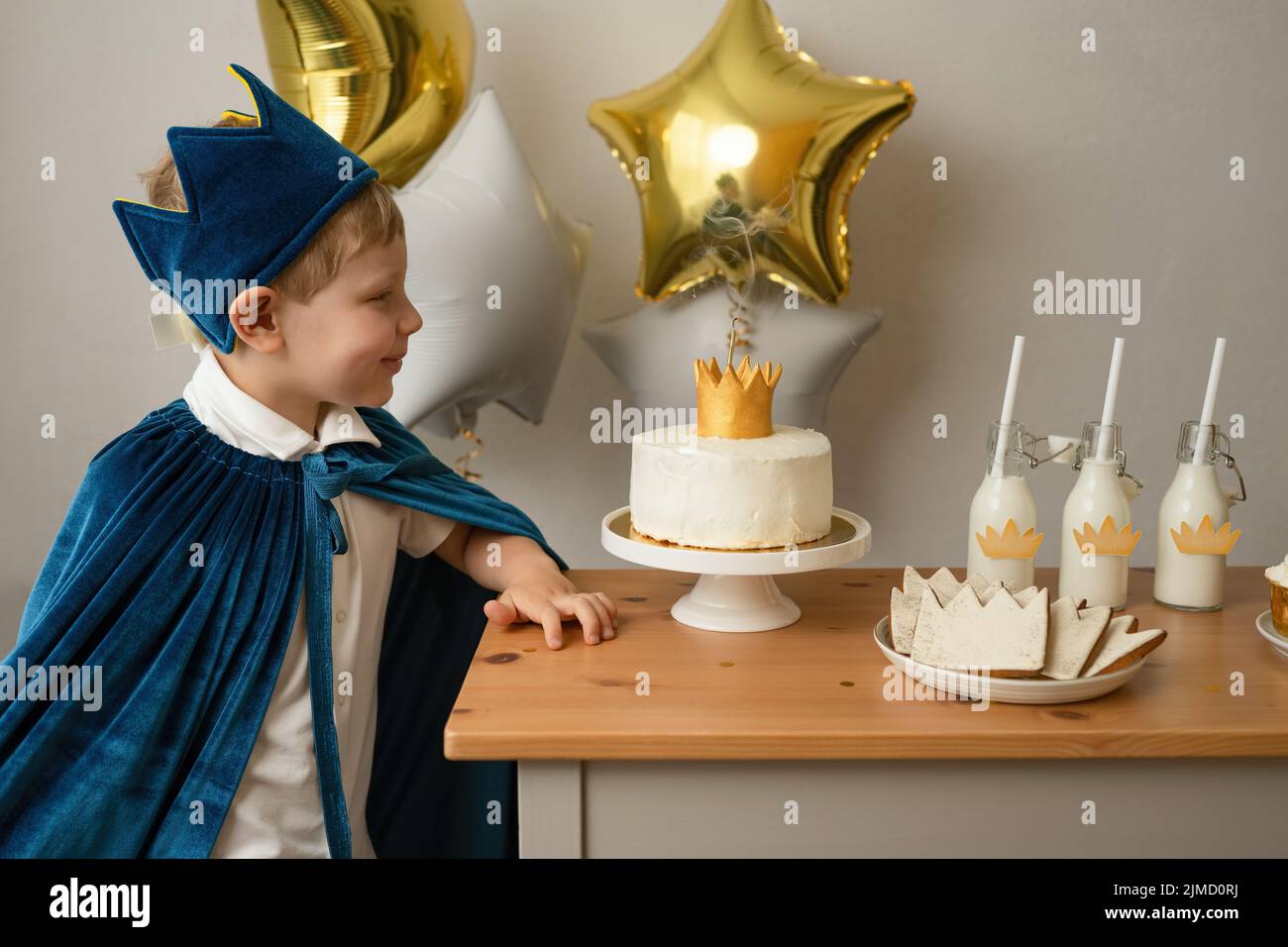 Side view blond boy preparing to blow out candles at a birthday party