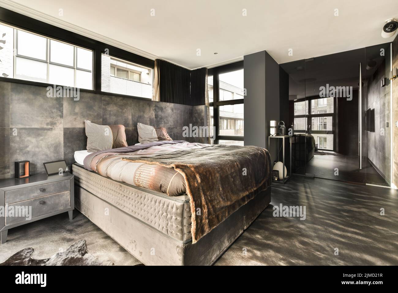 luxury modern and stylish bedroom in a modern house with big windows and king size bed Stock Photo