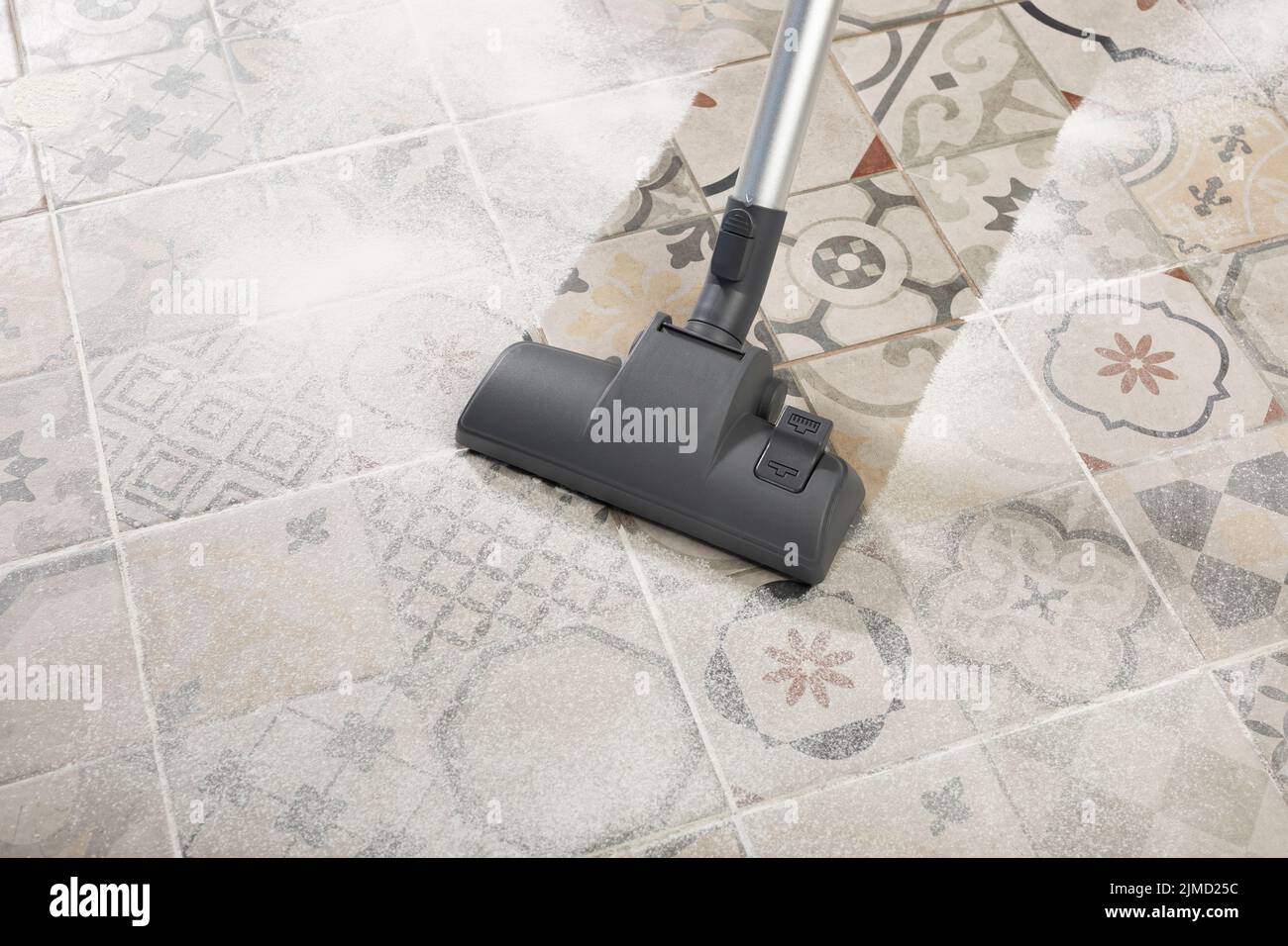 Cleaning floor with modern vacuum cleaner in kitchen room. easy cleaning with vacuum cleaner