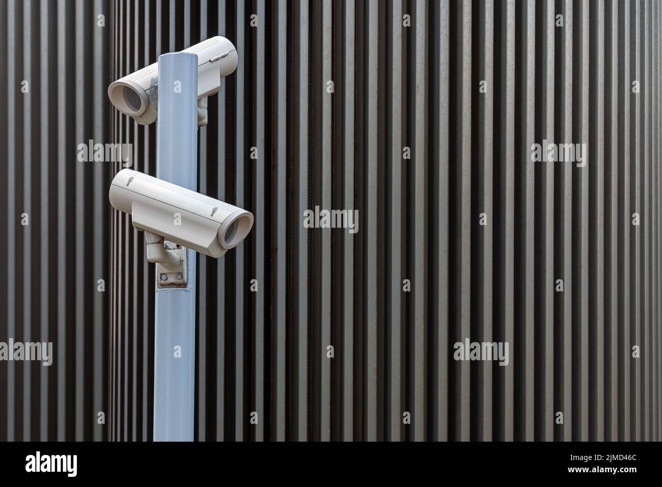 Security surveillance cameras against modern urban background Stock