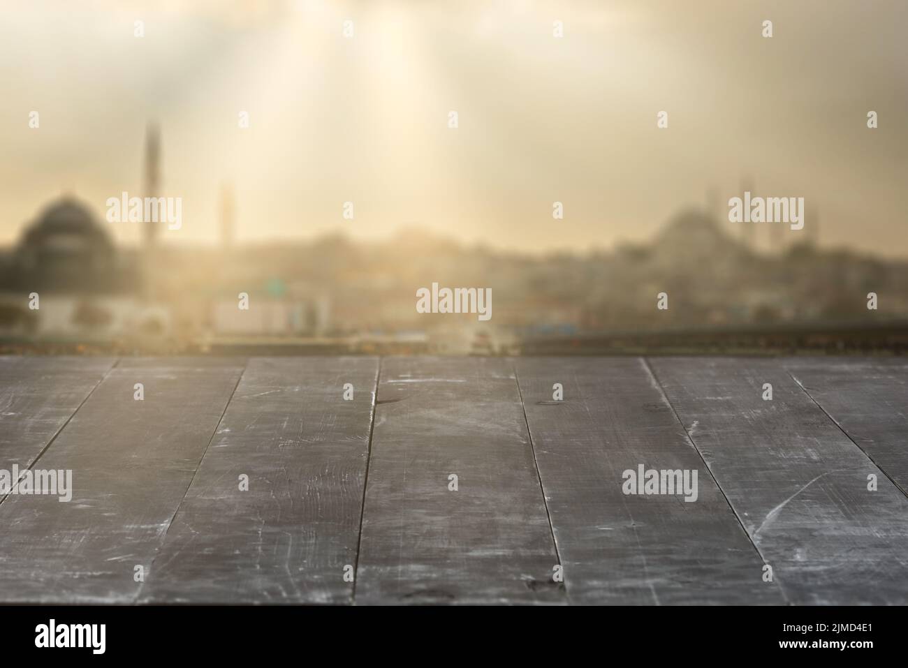 Old wooden dark grey table for display your products on a blurred
