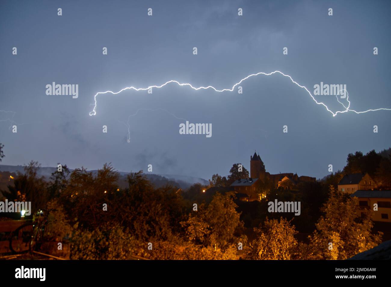 Castle photographed during a thunderstorm with lightning at night in Germany Stock Photo