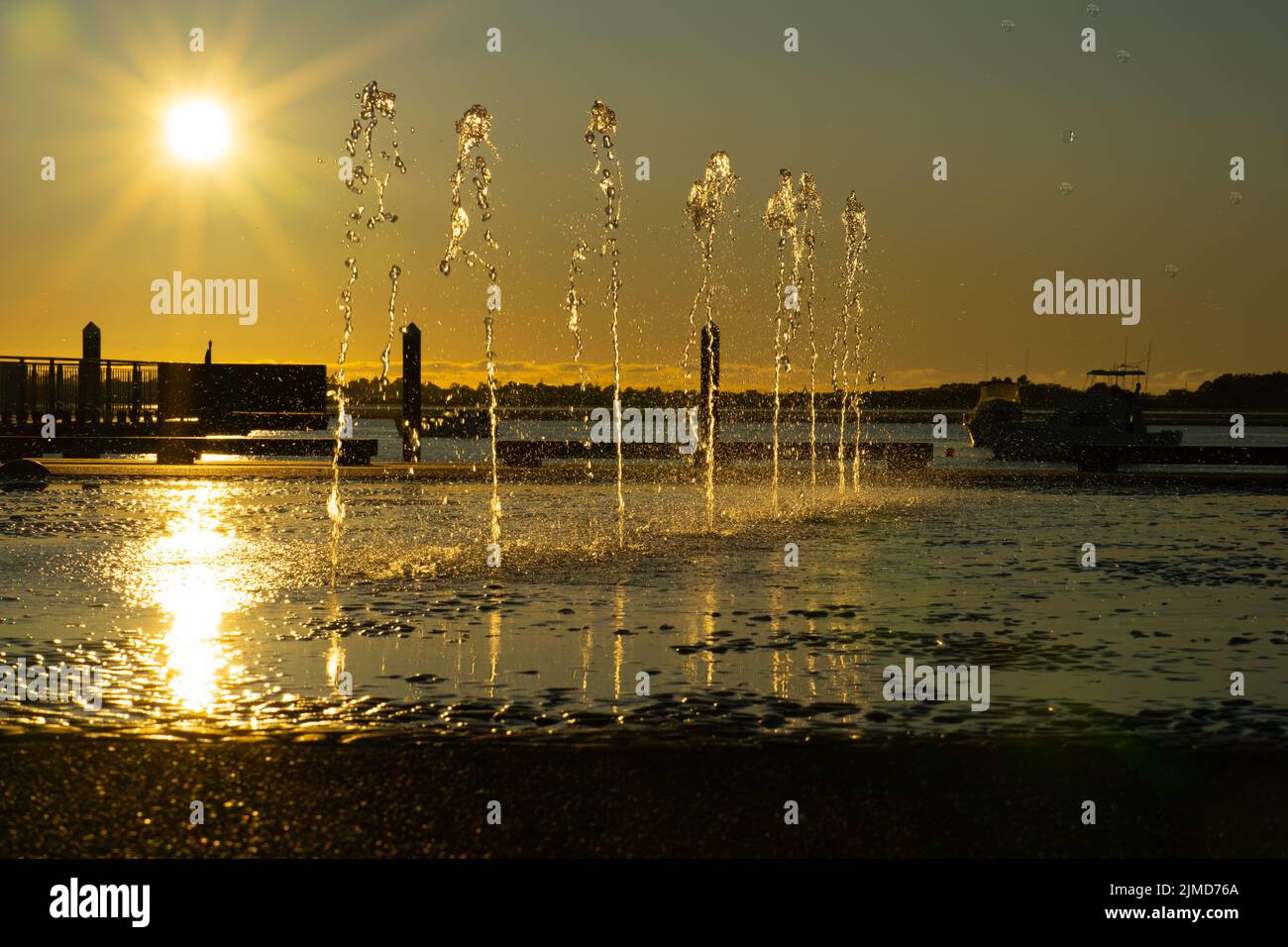 Water feature spraying waters in morning light on Tauranga Strand waterfront Stock Photo