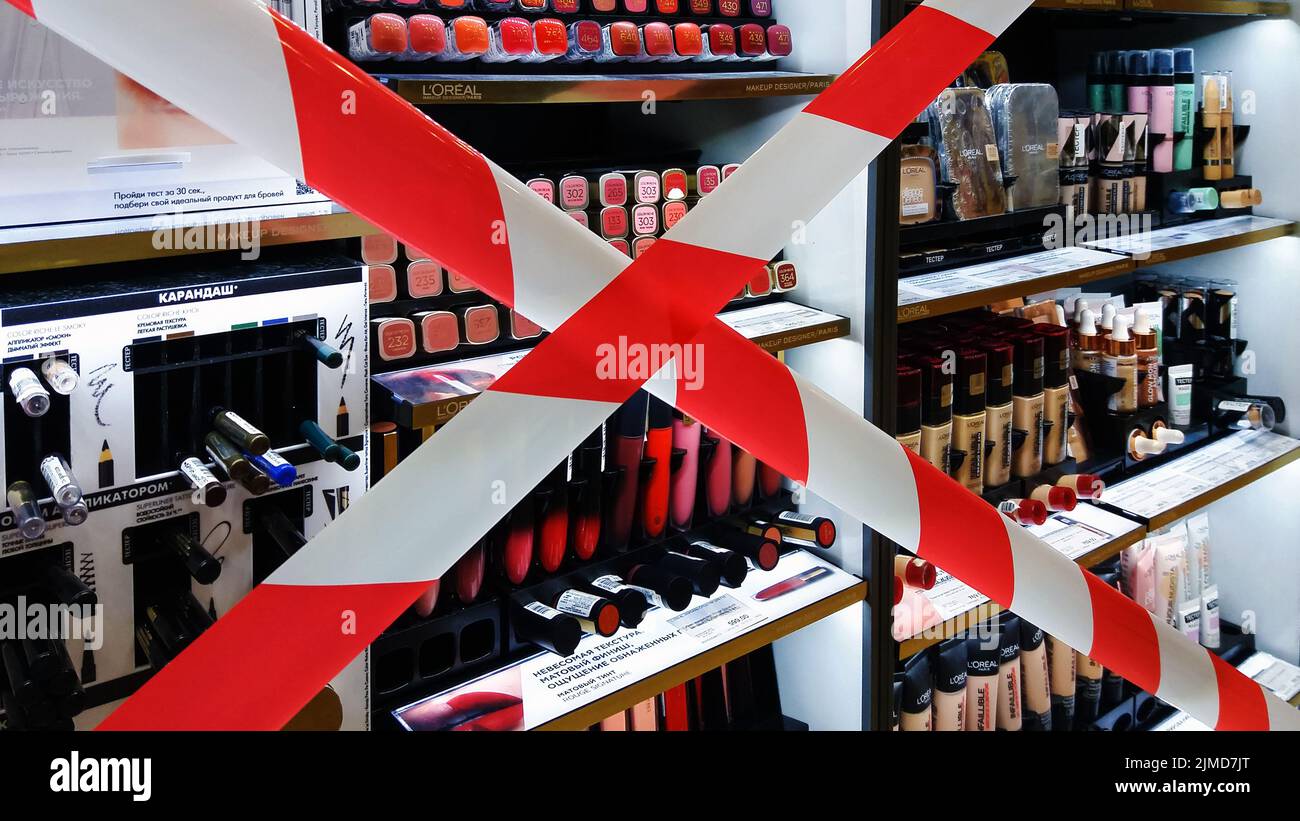 Barrier tape cross on decorative cosmetics store display forbidden for testing, Moscow 20/08/2020 Stock Photo
