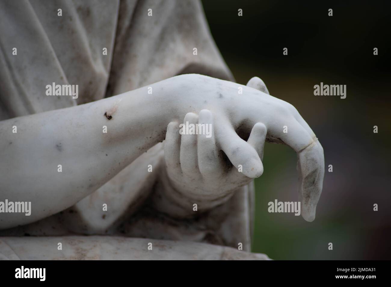 Stone sculpted hands of Jesus and Mary in a Victorian cemetery Stock Photo