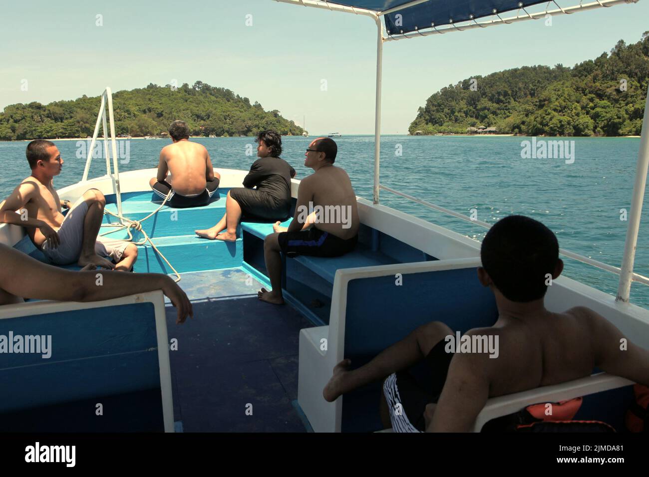 A group of journalists having a leisure time on boat after a sea walking session organized by Air Asia near Pulau Sapi (Sapi Island), a part of Tunku Abdul Rahman Park in Sabah, Malaysia. Stock Photo