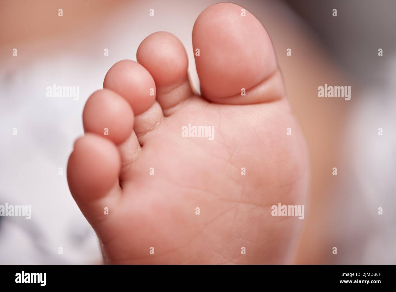 Tickle them...I dare you. an unrecognisable babys adorable feet at home. Stock Photo