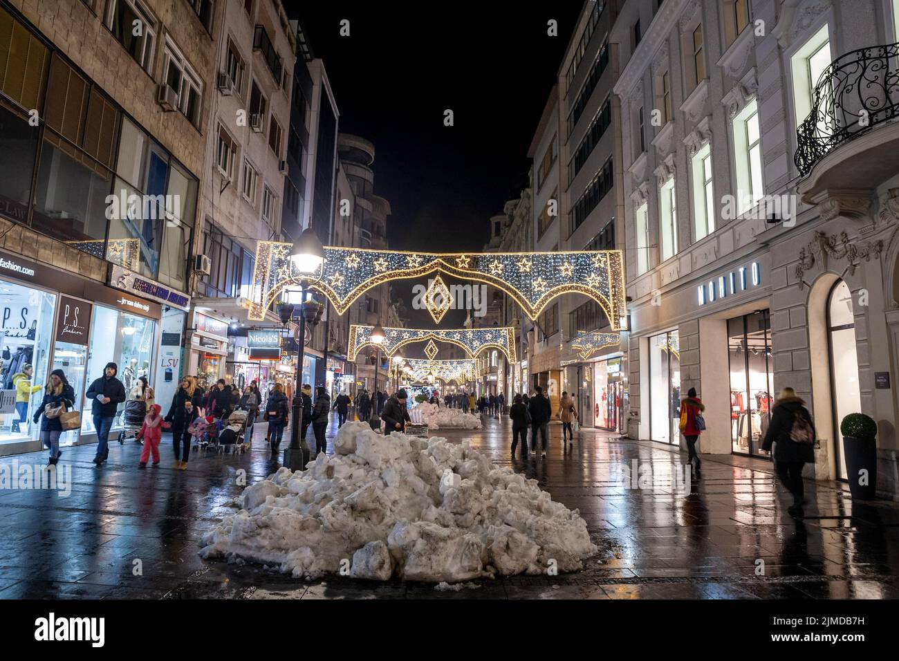 Picture of the crowded Kneza Mihailova street in belgrade, Serbia, illuminated for christmas, with snow, in december. Stock Photo