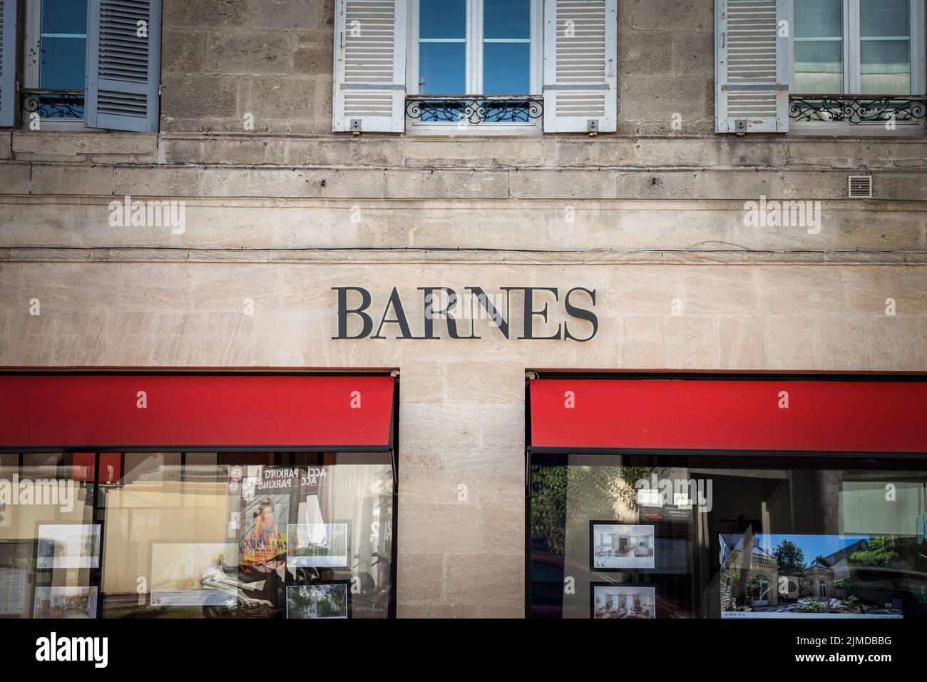 Picture of a sign with the logo of Barnes international realty taken on their agency in the city center of Bordeaux, France. Barnes Reealty is a Frenc Stock Photo