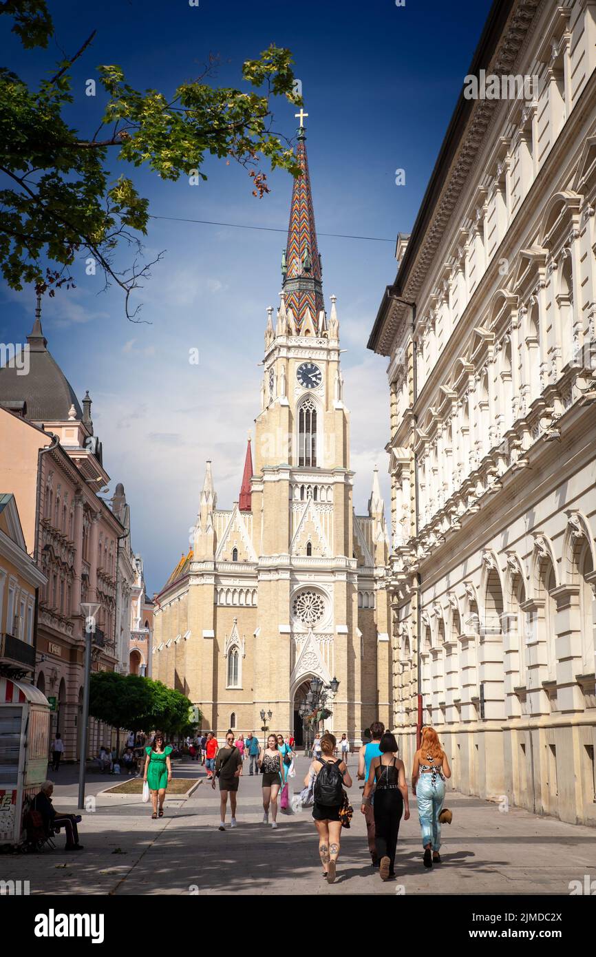 Picture of the Novi Sad cathedral on Trg Slobode square with pedestrians passing by. The Name of Mary Church is a Roman Catholic parish church dedicat Stock Photo