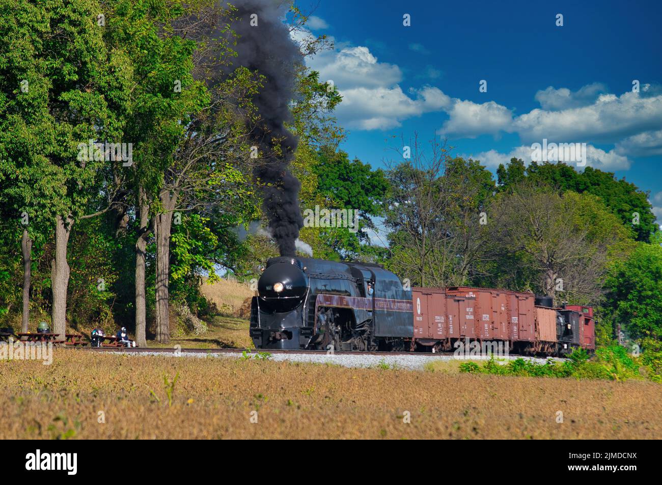 Antique Steam Freight Train Puffing Smoke and Steam Stock Photo