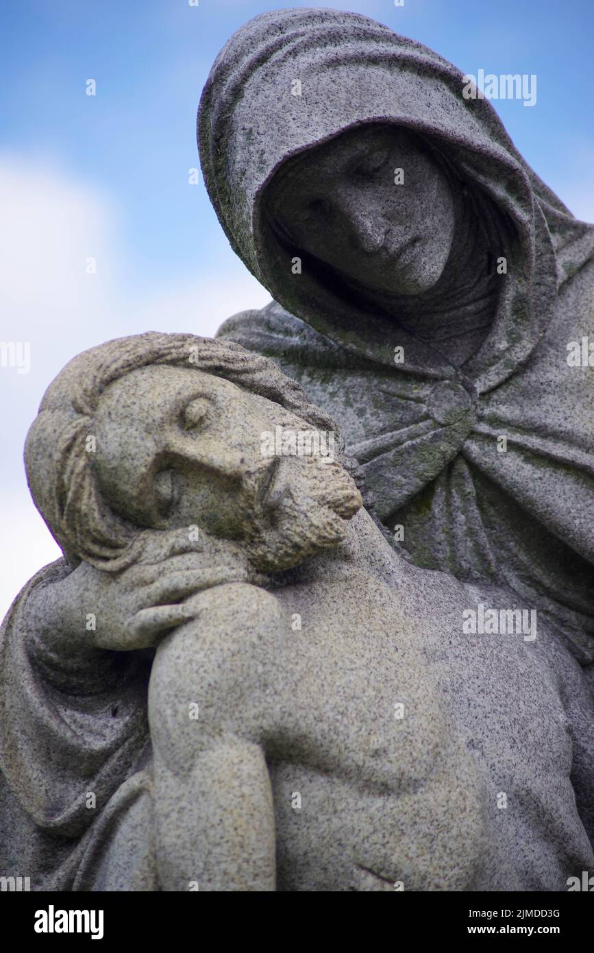 Close up of Jesus in Mary's arms old cemetery statue pieta Stock